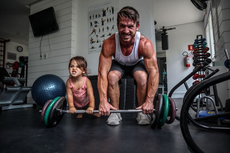 Dad and child working out together in a home gym